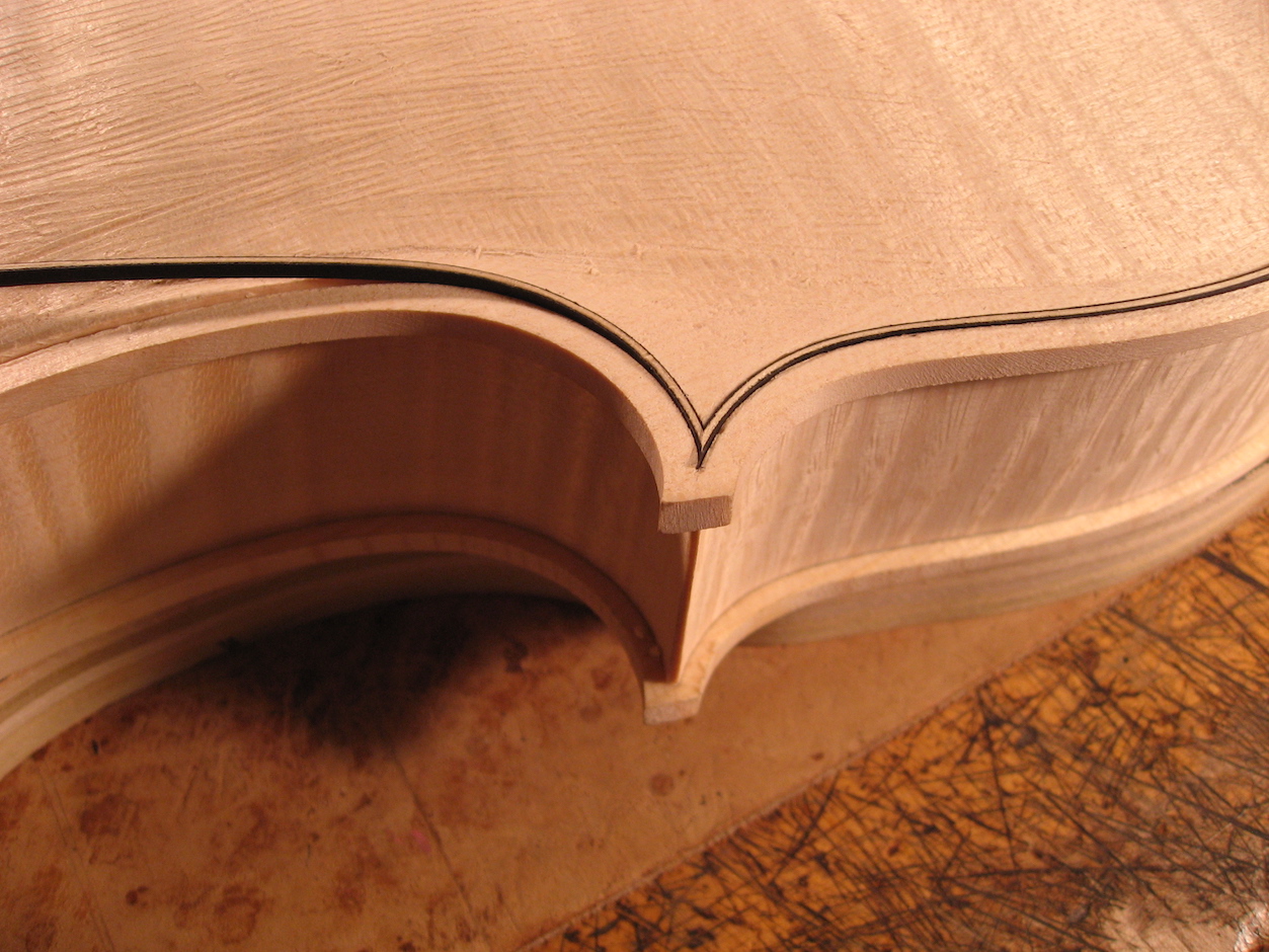 The purfling is inlaid with a precise miter at each corner