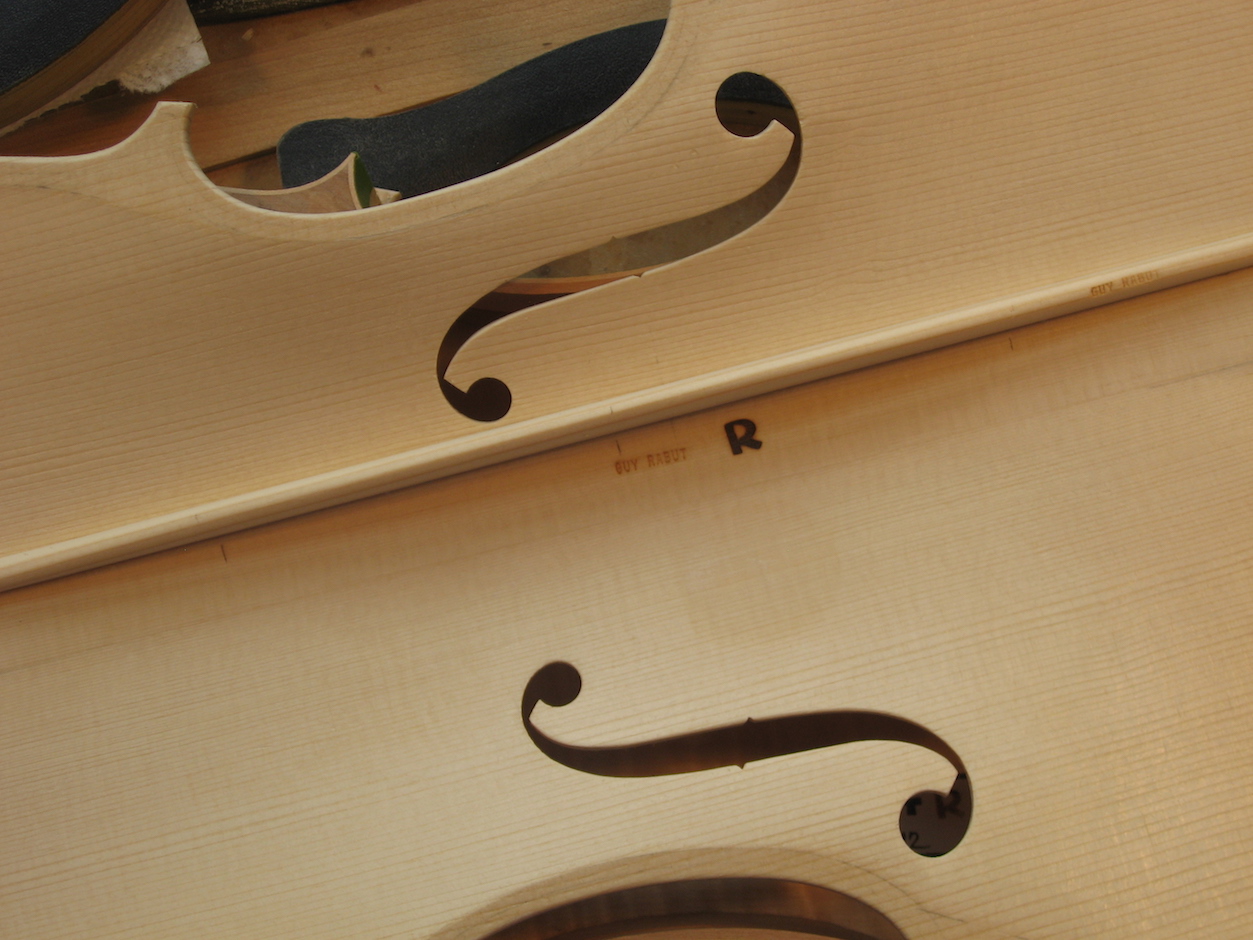 The inside of the finished top with the bass bar trimmed and the makers mark branded into the wood
