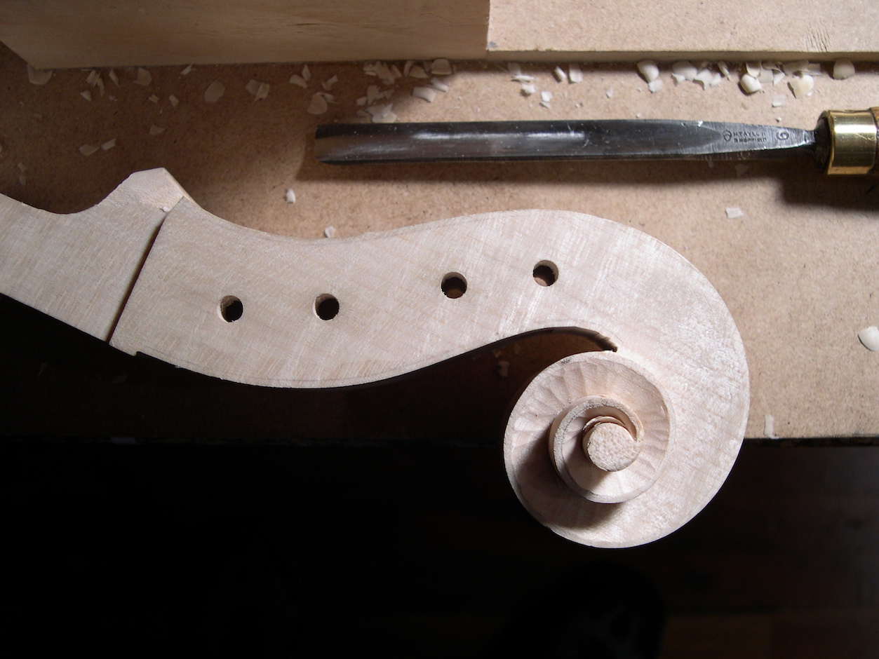The turns of the volute are carved with various gouges to reveal the final form